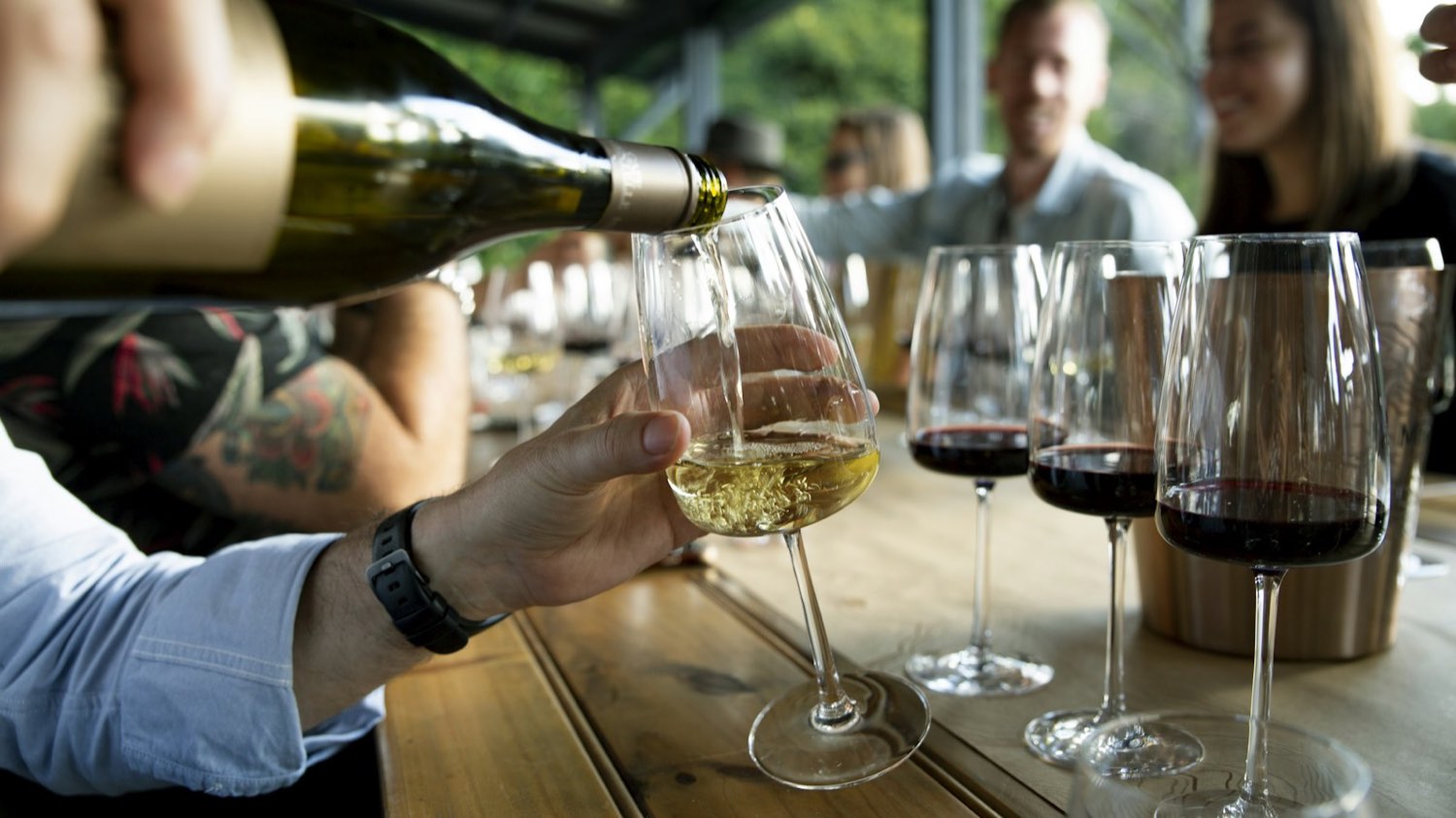 Wine being poured at a tasting bar